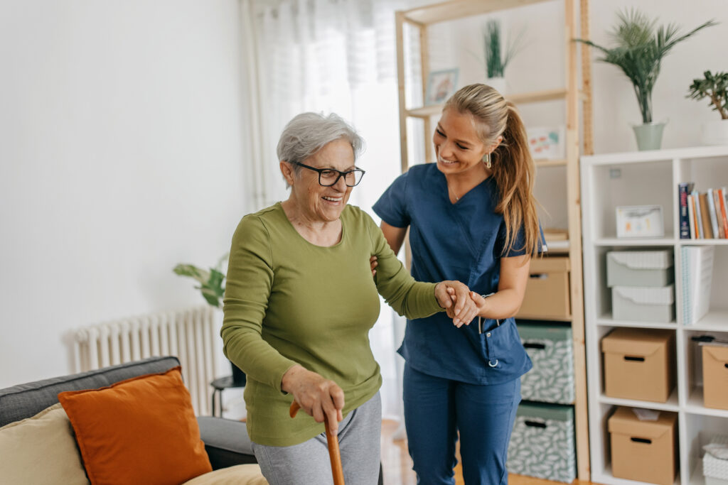 Individual support worker assisting an elderly person at home, showcasing career paths available with a Certificate III in Individual Support.