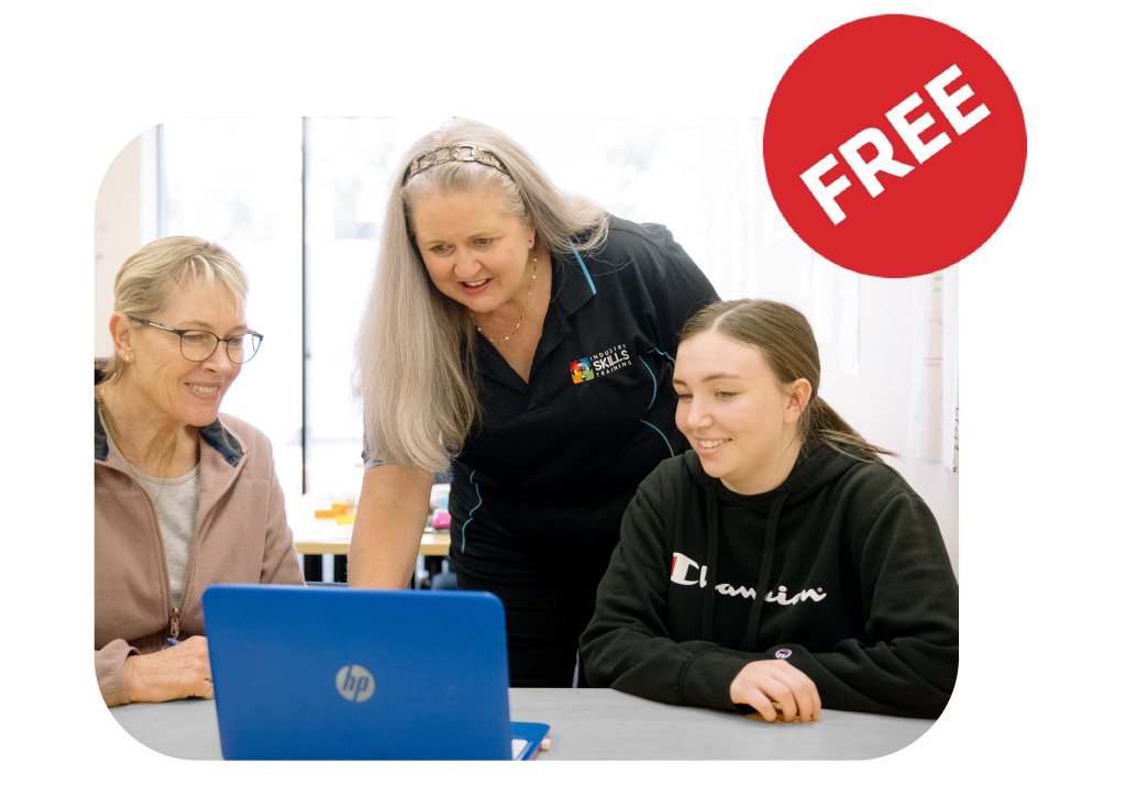 Trainer with two joyful students looking at a laptop, illustrating the satisfaction of engaging in IST's fee free training programs.